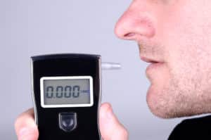 Man taking breathalyzer BAC Test